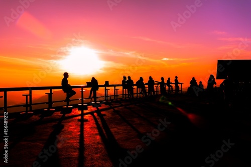Many tourists watch the morning sunrise on the mountain.