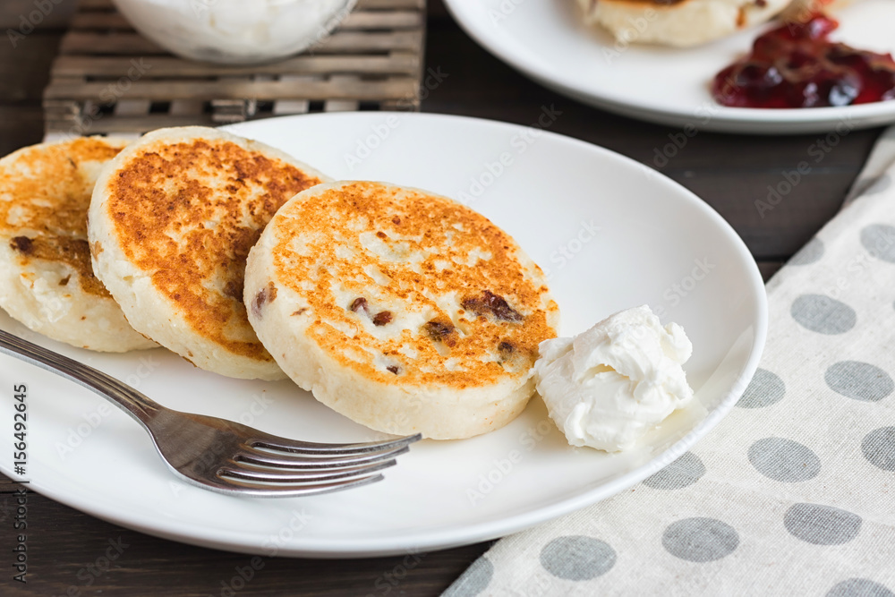 Cheesecakes for breakfast on a dark wooden background