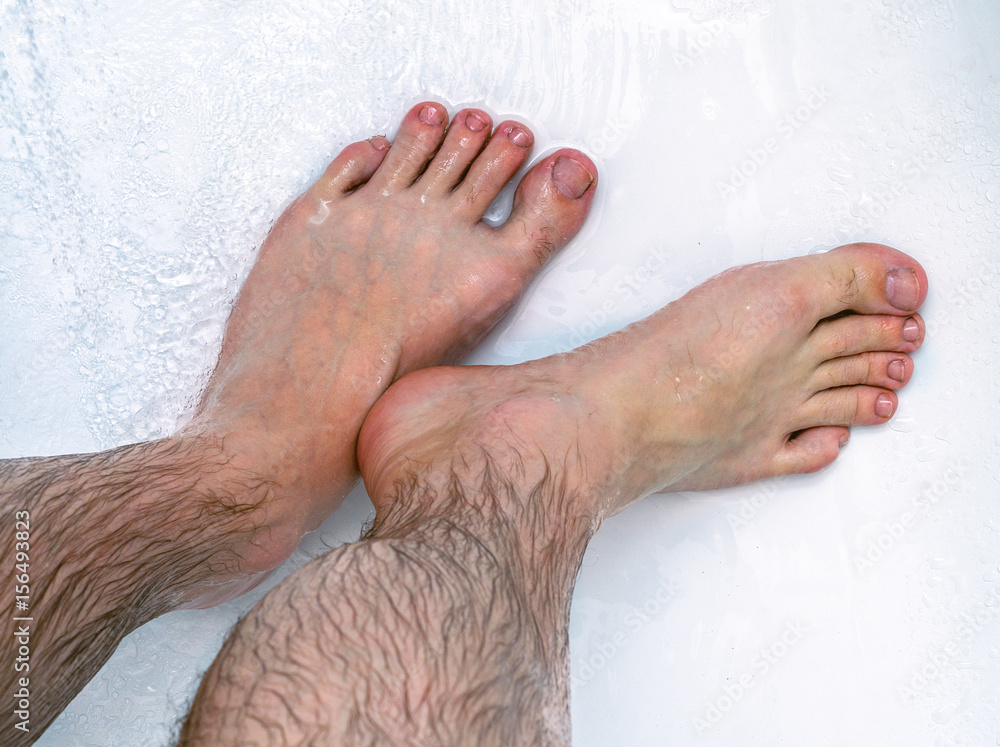 Men's hairy legs in the bathroom. A man washes in the shower Stock Photo |  Adobe Stock