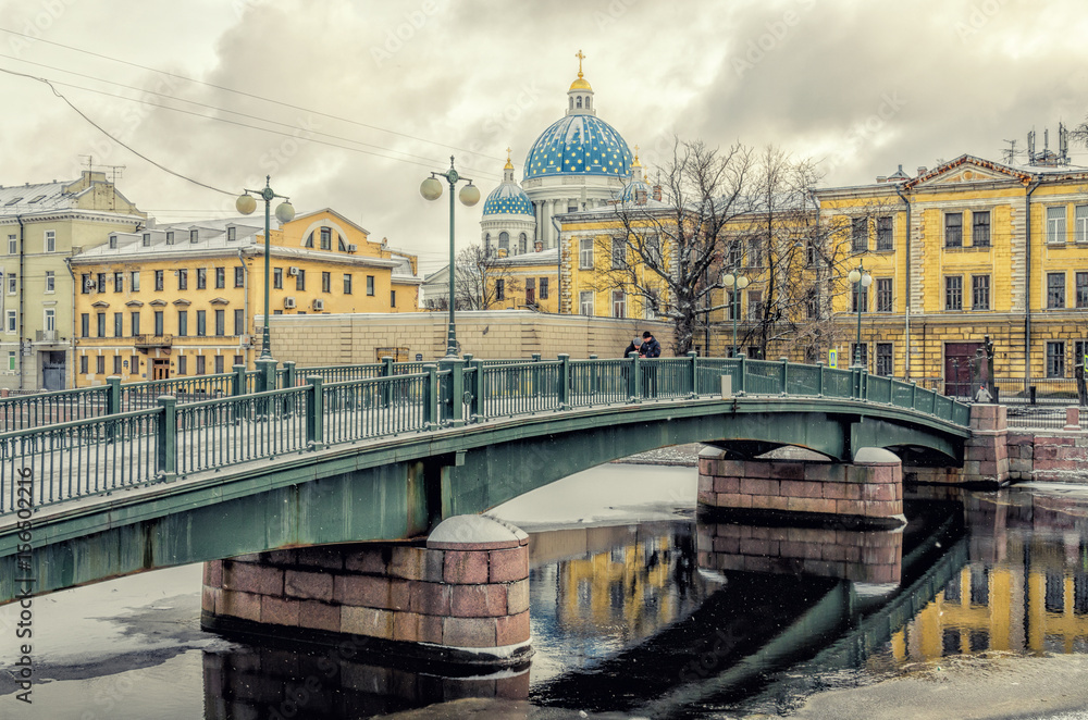 Naklejka premium The Krasnoarmeyskiy (Red Army) bridge and The Trinity Cathedral in the distance.
