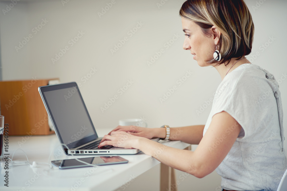 Caucasian freelancer using laptop in modern home office Caucasian freelancer using laptop in modern home office