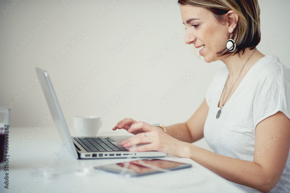 Caucasian freelancer using laptop in modern home office Caucasian freelancer using laptop in modern home office