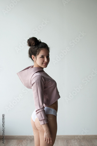 pretty girl in crop top stand in profile and look to camera