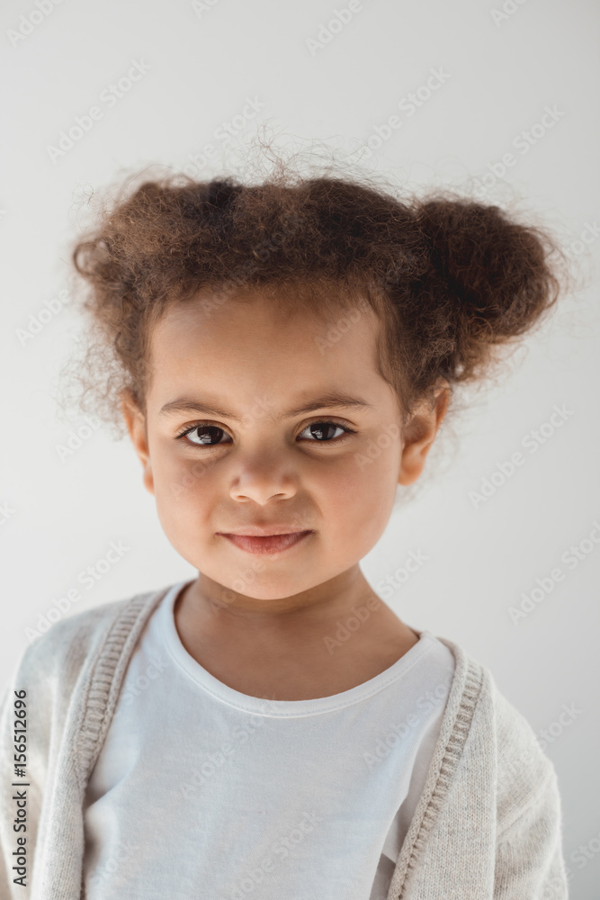 portrait of adorable little kid girl looking at camera isolated on white portrait of adorable little kid girl looking at camera isolated on white
