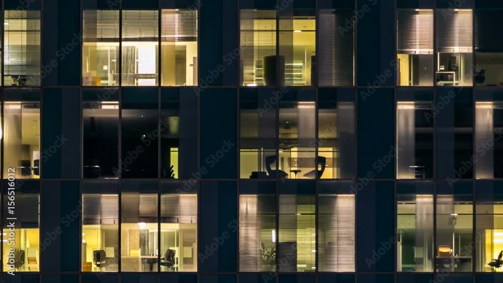 window of the multi-storey building of glass and steel lighting and people within timelapse window of the multi-storey building of glass and steel lighting and people within timelapse