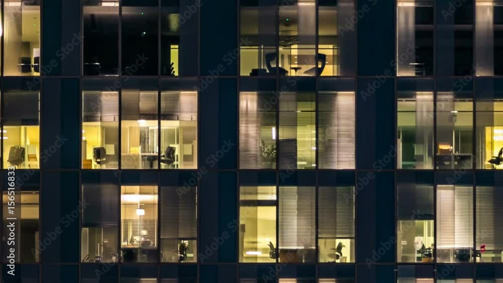window of the multi-storey building of glass and steel lighting and people within timelapse window of the multi-storey building of glass and steel lighting and people within timelapse
