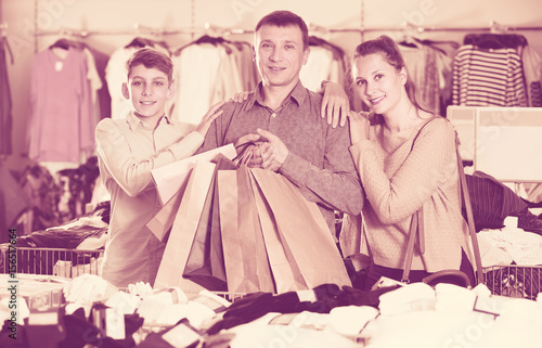 Couple and teenager with shopping bags