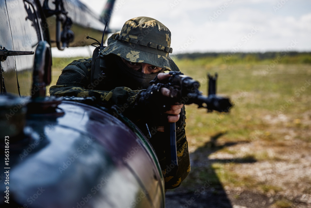 Fototapeta premium Photo of a soldier with an automatic rifle