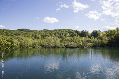 Landscape with beautiful luxuriant nature, lake and blue sky with clouds at "Plitvice Lakes" National Park, Croatia