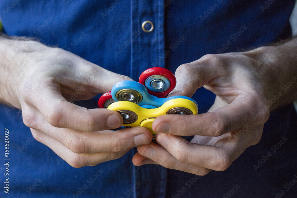 Fototapeta premium A person holding popular fidget spinner toy
