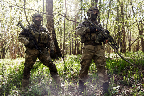 Two soldiers with machine guns