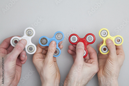 Hands holding popular fidget spinner toy photo