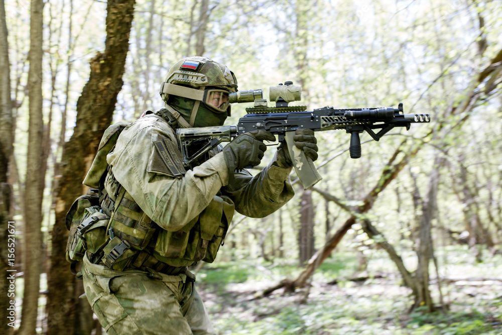 Soldier takes aim in forest