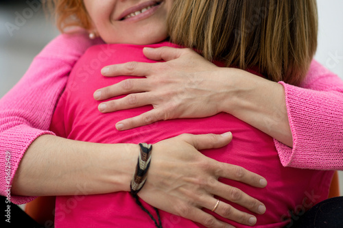 Two women are hugging