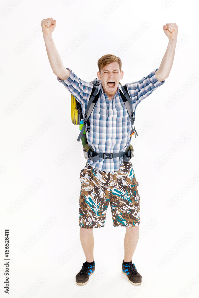 Hiker man with backpack rising arms in victory sign on white background