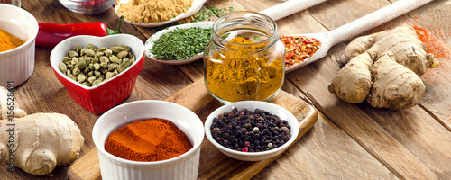 Colorful spices on rustic wooden background.