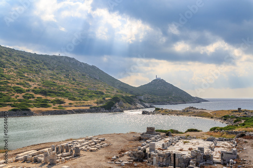 Ancient greek city knidos remmants and lighthouse with sun rays photo