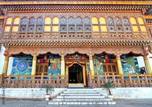 Entrance of Punakha Dzong or Pungthang Dewachen Phodrang monastery decorated with colorful Bhutanese patterns wooden window frames, Punakha, Bhutan.