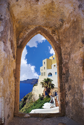 Santorini island through an old Venetian window, Greece photo