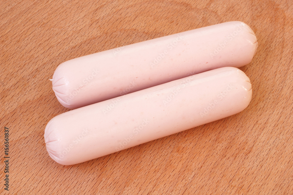 Two pork meat sausages on wooden background Two pork meat sausages on wooden background