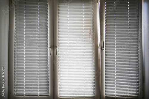 Closed blinds on the window © kichigin19