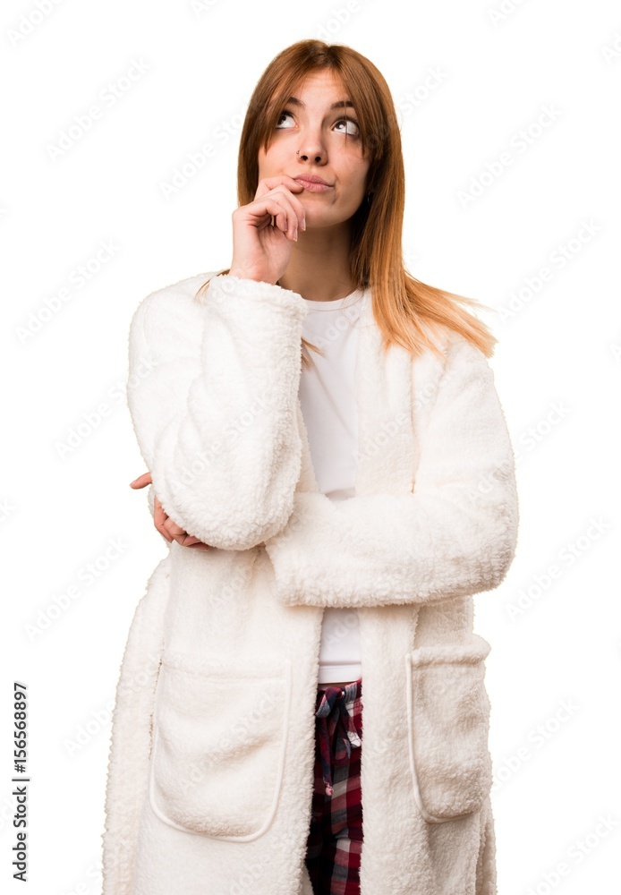 Young woman in dressing gown thinking Young woman in dressing gown thinking