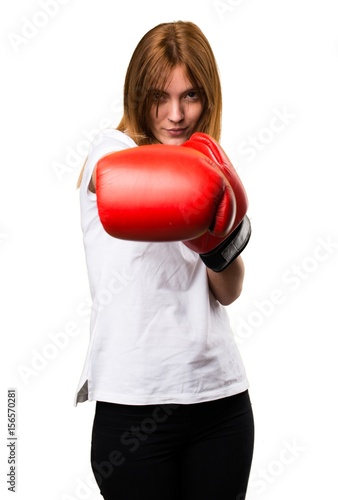 Beautiful young girl with boxing gloves