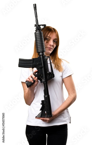 Beautiful young girl holding a rifle