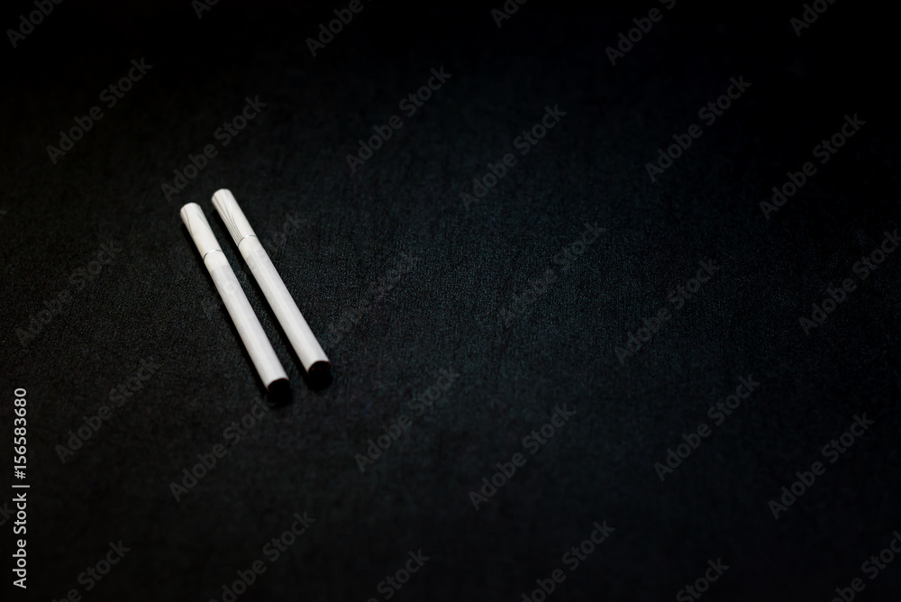 Naklejka premium Cigarettes closeup on a black background. Stop quit Smoking background. Concept Quitting smoking. World No Tobacco Day
