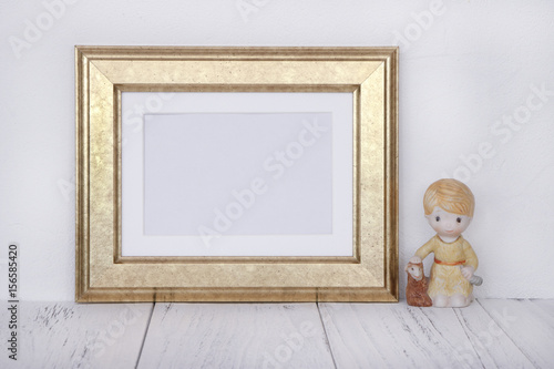 Stock photography golden picture frame ceramic boy doll mock up for text message
