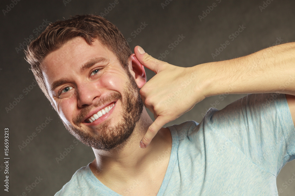 Obraz premium Happy man showing call me gesture.