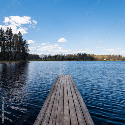 reflection of clouds in the lake with boardwalk