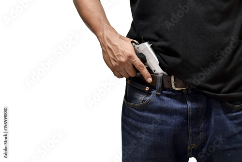 The man pulls out a gun tucked in his pant
