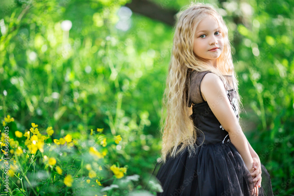 Beautiful child girl in yellow garden Beautiful child girl in yellow garden