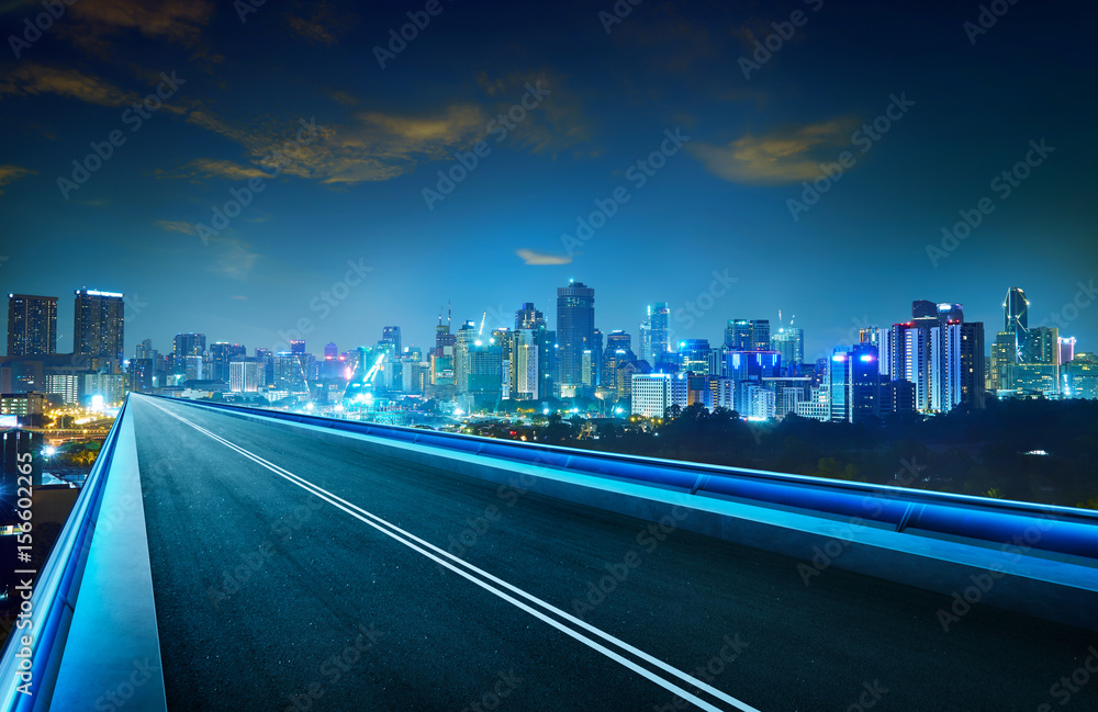 Obraz premium Empty asphalt flyover with city skyline ,night scene .