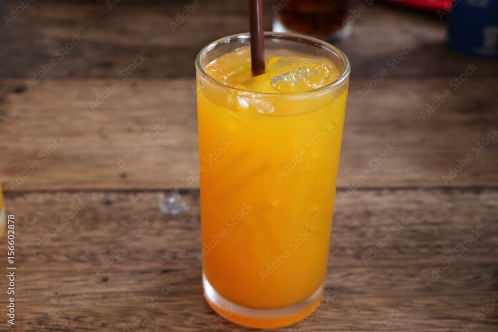 Orange juice in glass with plastic tube Orange juice in glass with plastic tube