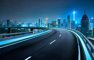 Moving forward motion blur flyover with city skyline ,night scene .