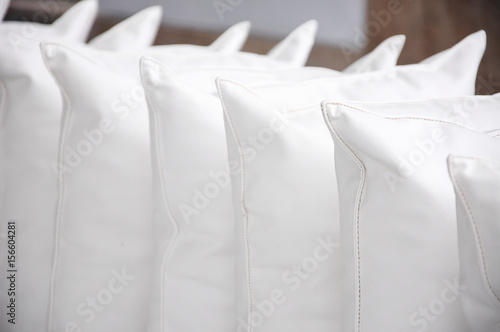 white pillows leather on cushion