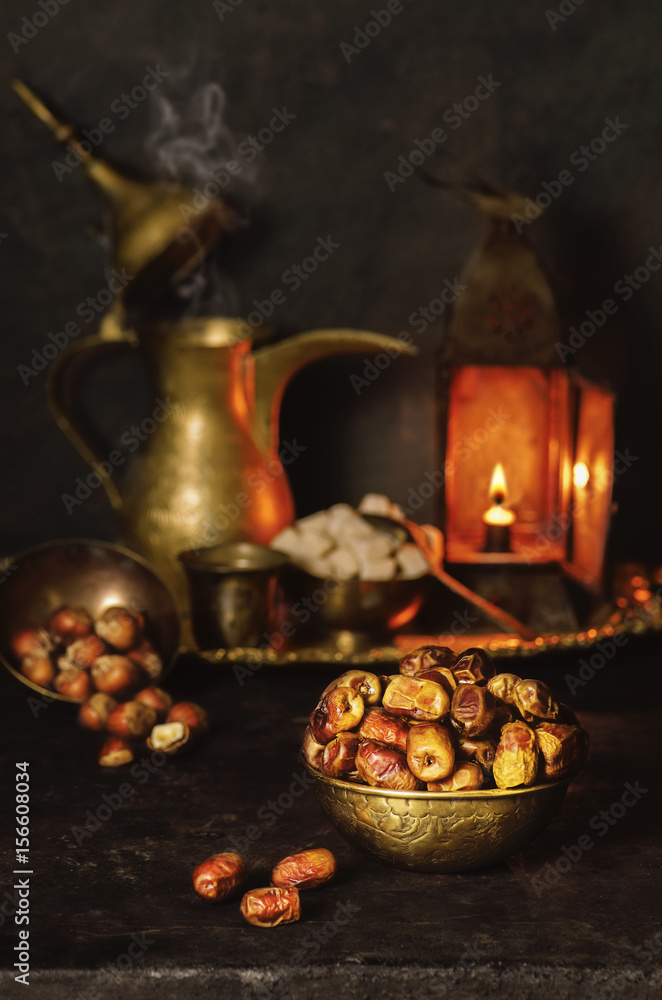 Ramadan Background with delicious premium  dates places with traditional old lamp,arabian coffee  pot,sugar and nuts..Ramadan food 