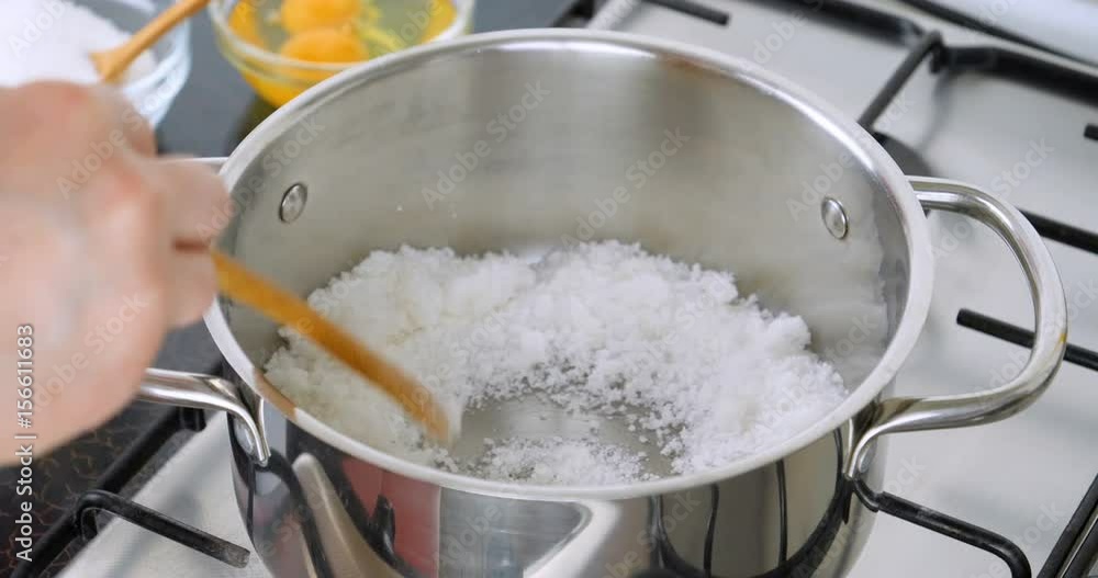 Melting sugar for caramel sauce. Cooking caramel. Chef preparing caramel in the pan. Boil sugar. The technical process of preparation of caramel. 4K footage at 48FPS for slow motion. Melting sugar for caramel sauce. Cooking caramel. Chef preparing caramel in the pan. Boil sugar. The technical process of preparation of caramel. 4K footage at 48FPS for slow motion.
