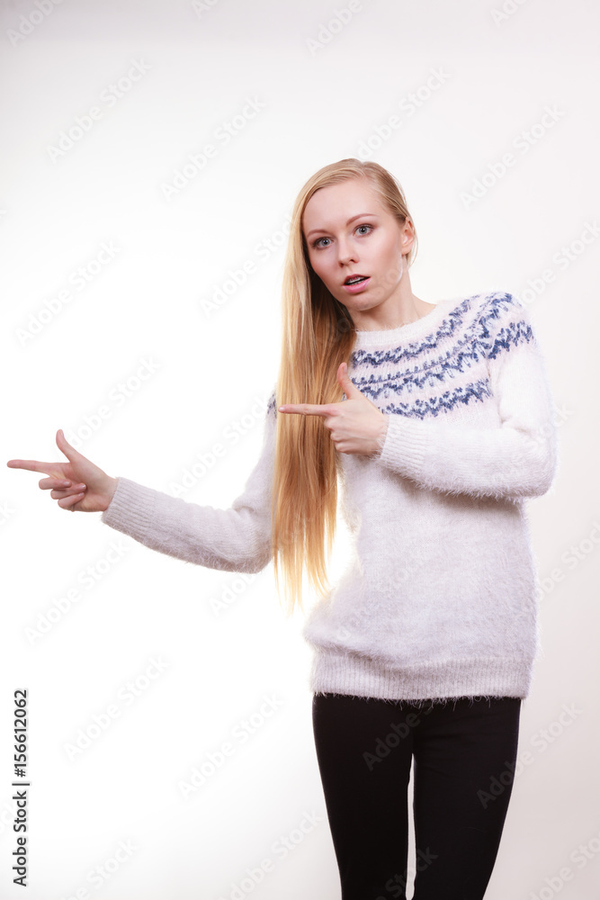 Teenage blonde woman pointing at copyspace Teenage blonde woman pointing at copyspace