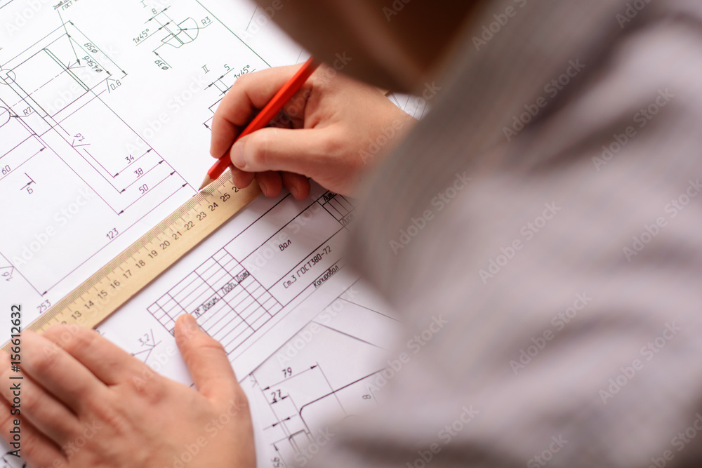 Mechanical engineer at work. Technical drawings. Paper with technical drawings and diagrams. Mechanical engineer at work. Technical drawings. Paper with technical drawings and diagrams.