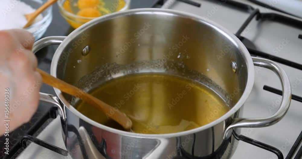 Cooking caramel. Chef preparing caramel in the pan. Boil sugar. The technical process of preparation of caramel. Shot 4K footage at 10 bit. Cooking caramel. Chef preparing caramel in the pan. Boil sugar. The technical process of preparation of caramel. Shot 4K footage at 10 bit.