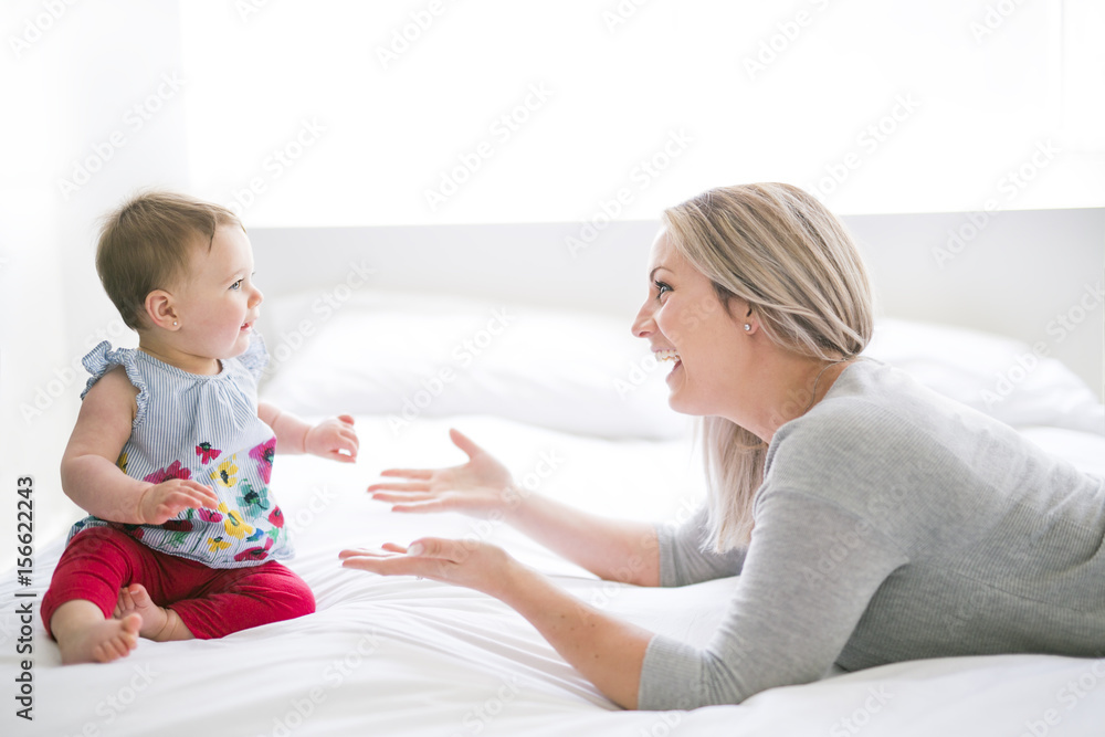 Pretty baby sit on mom in silk bed Pretty baby sit on mom in silk bed