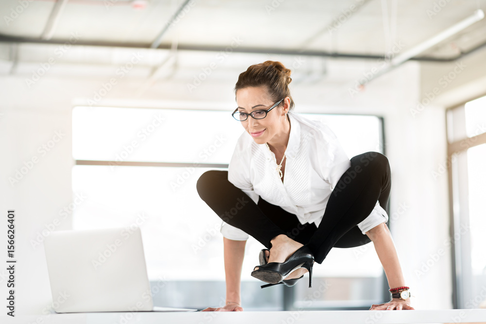 Outgoing woman having awkwarded pose in office Outgoing woman having awkwarded pose in office