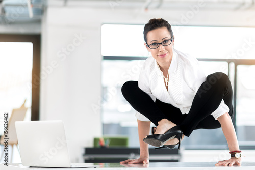Fotografie Cheerful female having uncomfortable posture in room