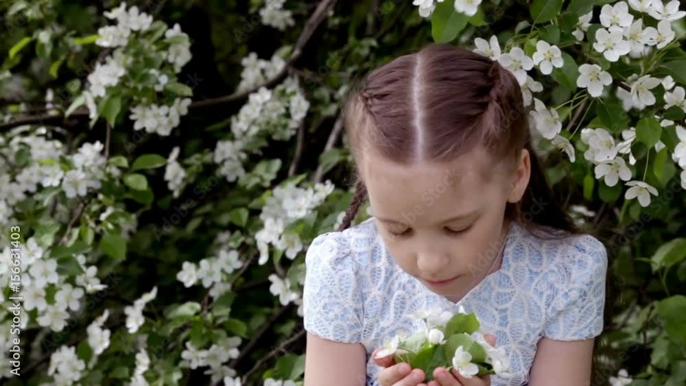 Cute little girl in blooming apple tree garden at spring Cute little girl in blooming apple tree garden at spring
