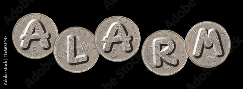 ALARM – Coins on black background