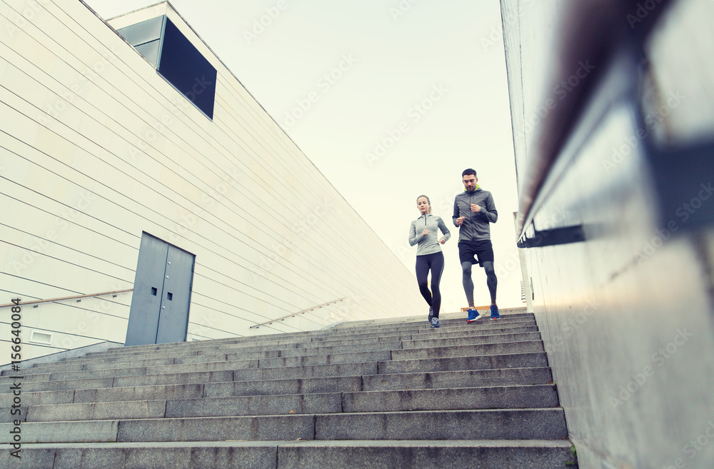 couple running downstairs on city stairs
