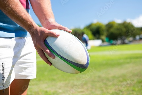 Close up of player holding rugby ball